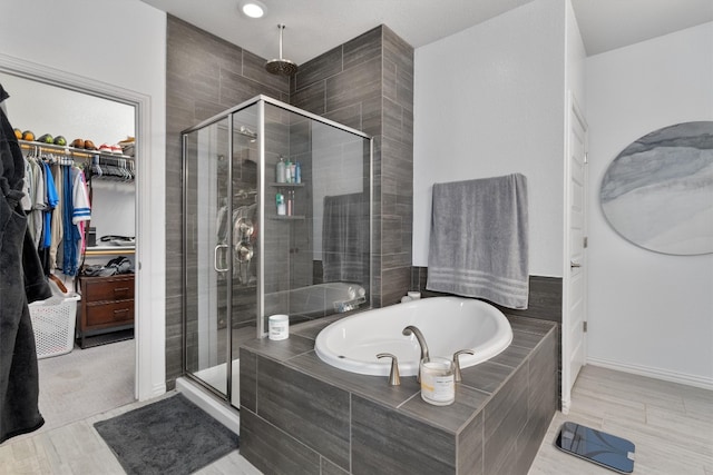 bathroom featuring hardwood / wood-style floors and independent shower and bath