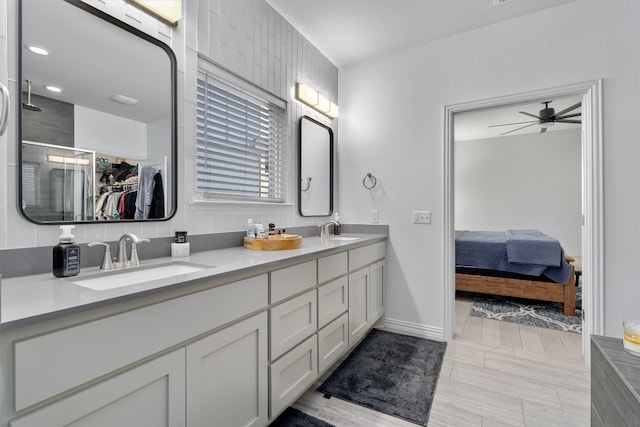 bathroom featuring vanity, wood-type flooring, a shower with door, and ceiling fan