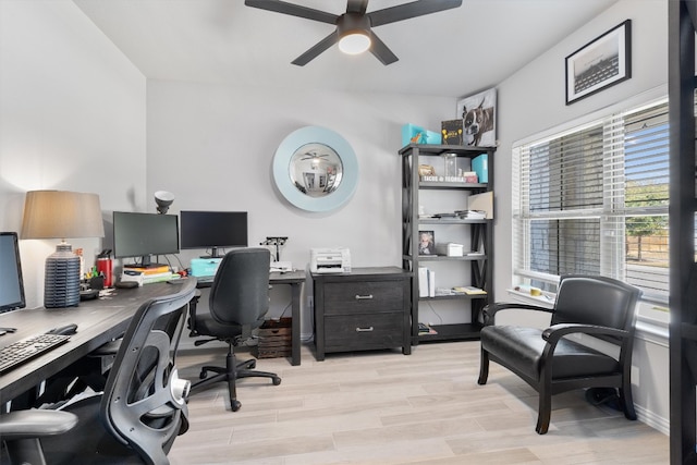 office area with light hardwood / wood-style floors and ceiling fan