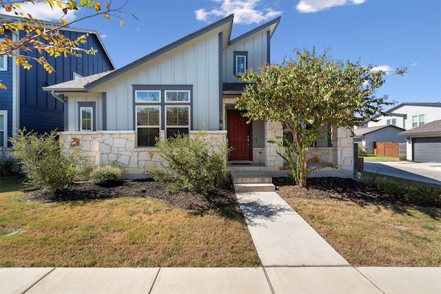 view of front of property with a front yard and a garage