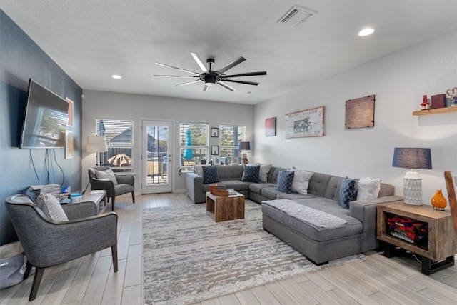 living room featuring ceiling fan and light hardwood / wood-style flooring