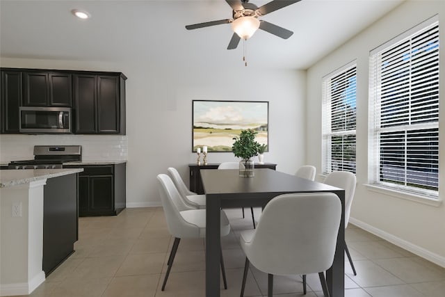 dining area featuring ceiling fan and light tile patterned floors