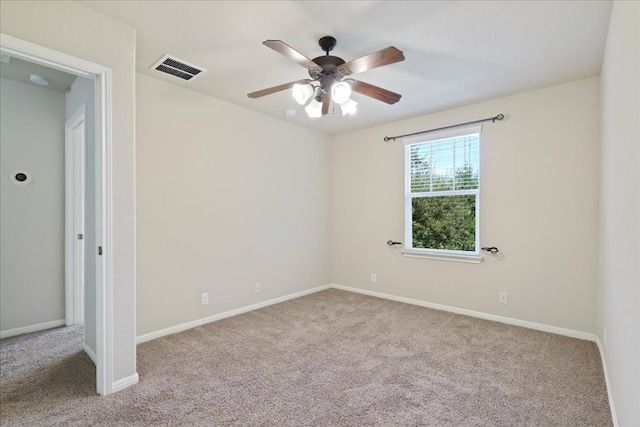 carpeted spare room featuring ceiling fan