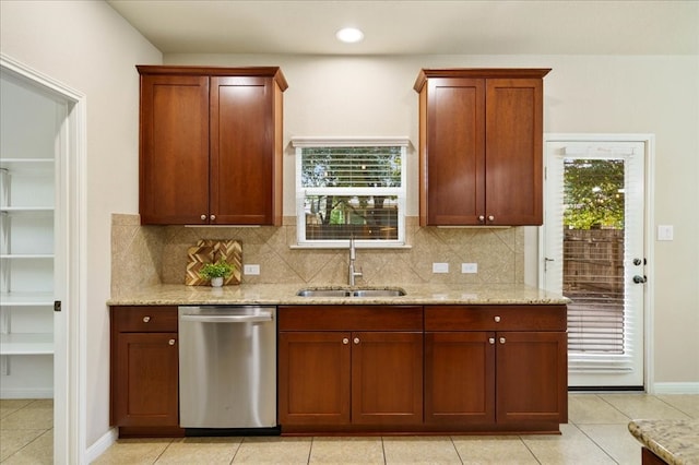 kitchen with dishwasher, sink, light tile patterned flooring, and plenty of natural light