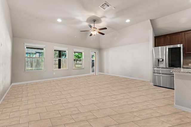 unfurnished living room featuring ceiling fan, a healthy amount of sunlight, and lofted ceiling