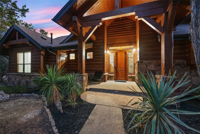 exterior entry at dusk with a patio area