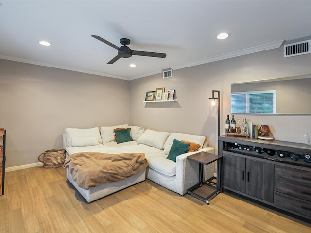 living room featuring light wood-type flooring, ceiling fan, and ornamental molding