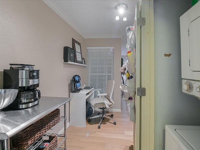 office area with stacked washer / drying machine, light wood-type flooring, and crown molding