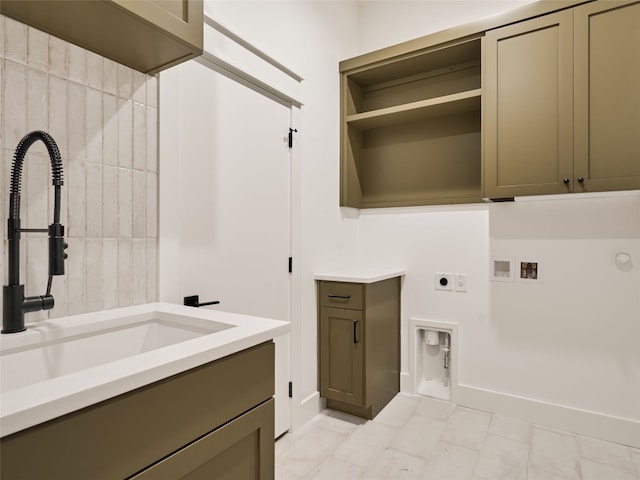 clothes washing area with cabinets, hookup for a gas dryer, sink, hookup for a washing machine, and hookup for an electric dryer