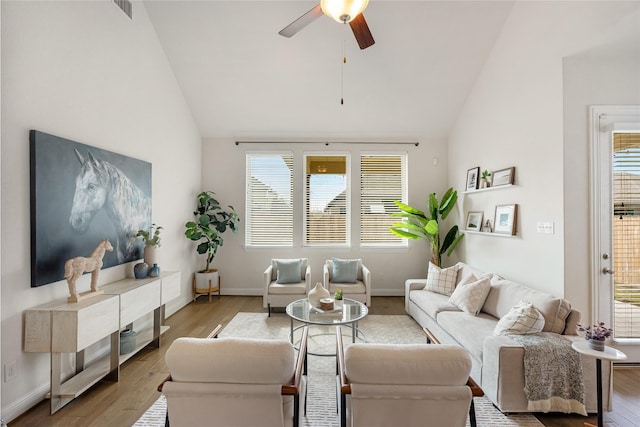 living room with ceiling fan, high vaulted ceiling, and hardwood / wood-style flooring