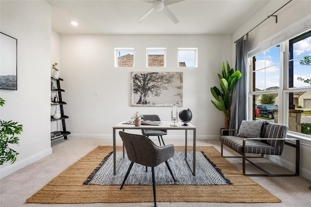 carpeted office featuring ceiling fan and plenty of natural light