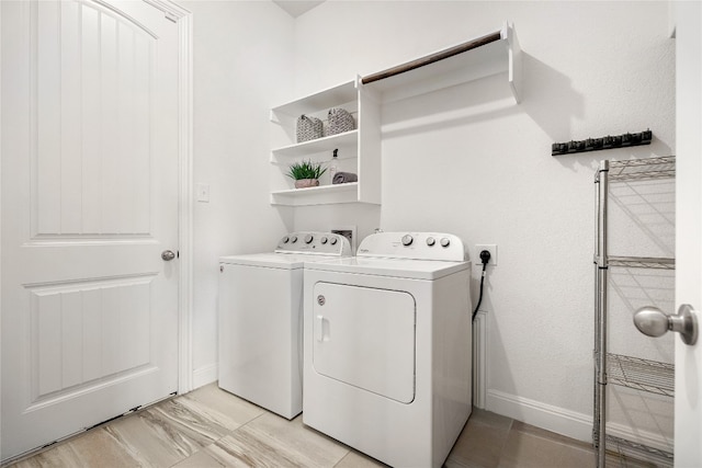 clothes washing area with separate washer and dryer