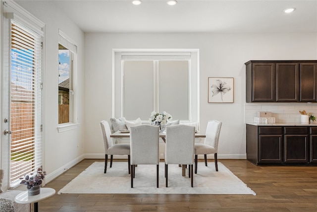 dining room featuring dark wood-type flooring and a wealth of natural light