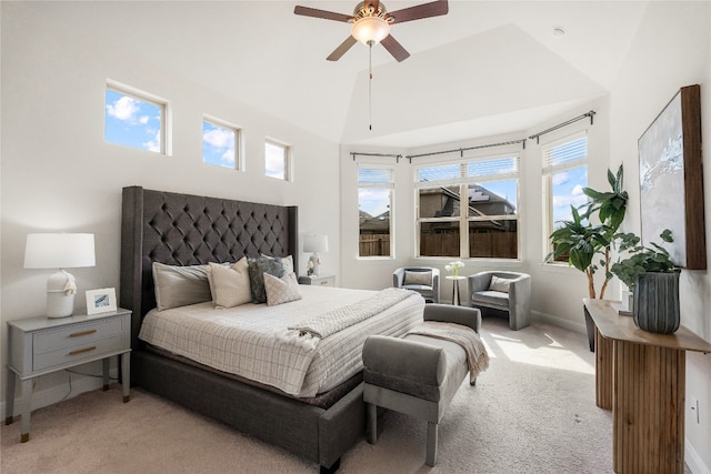 bedroom with ceiling fan, vaulted ceiling, and light colored carpet