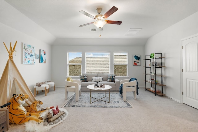 living room with light colored carpet, ceiling fan, and vaulted ceiling