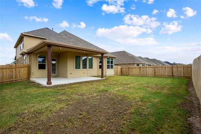 rear view of house featuring a patio and a lawn