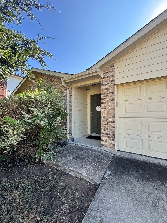 view of exterior entry featuring a garage