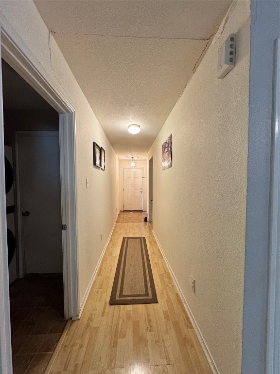 hallway with light hardwood / wood-style floors