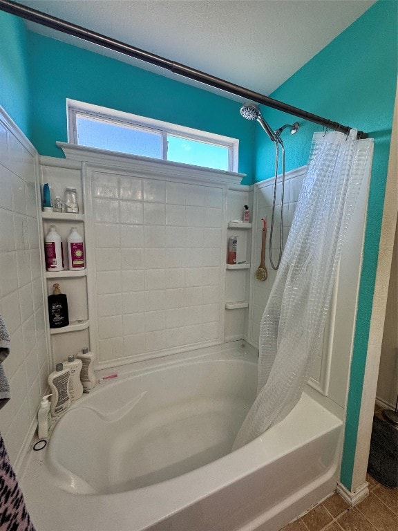 bathroom featuring shower / bath combo, tile patterned flooring, plenty of natural light, and a textured ceiling