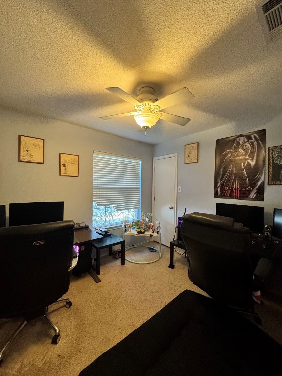 carpeted office featuring ceiling fan and a textured ceiling