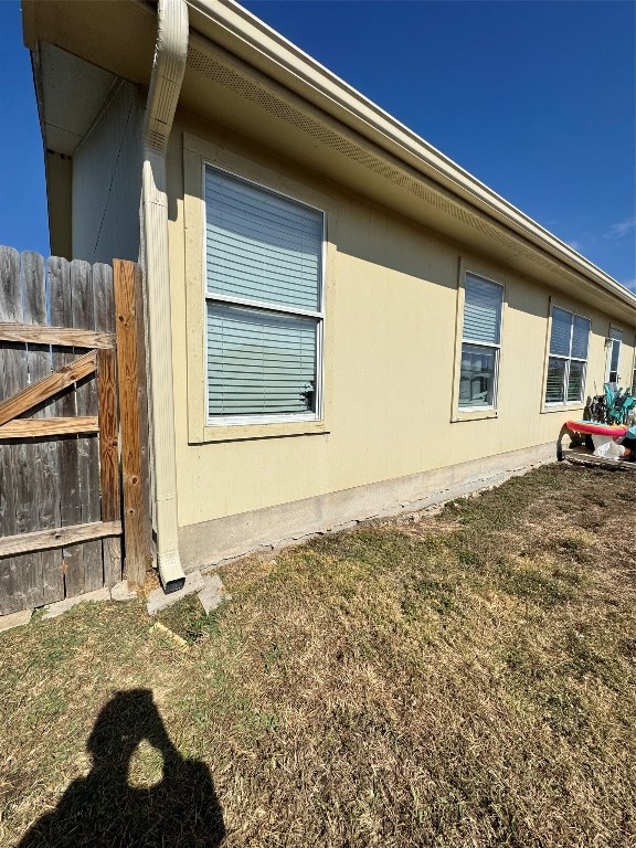 view of side of property with a lawn