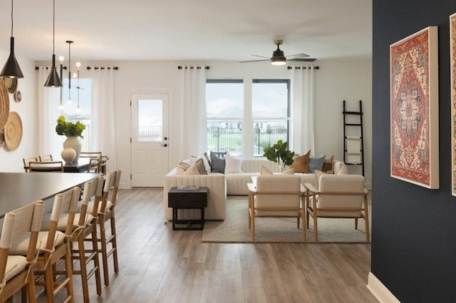 living room with hardwood / wood-style flooring and ceiling fan