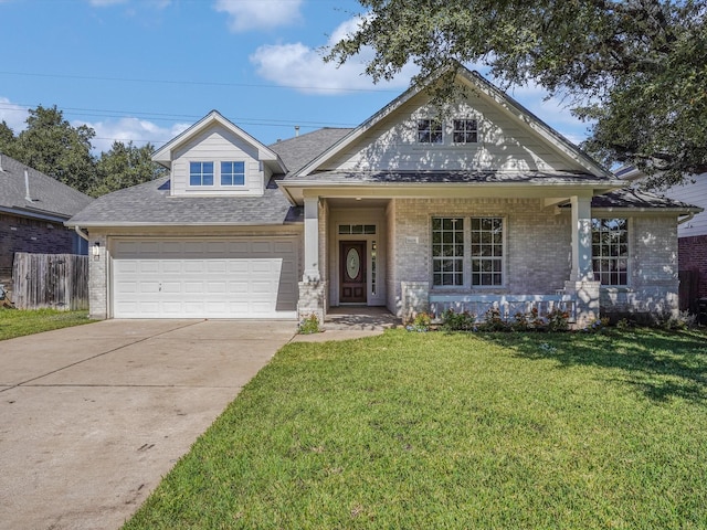 view of front facade featuring a front lawn, covered porch, and a garage