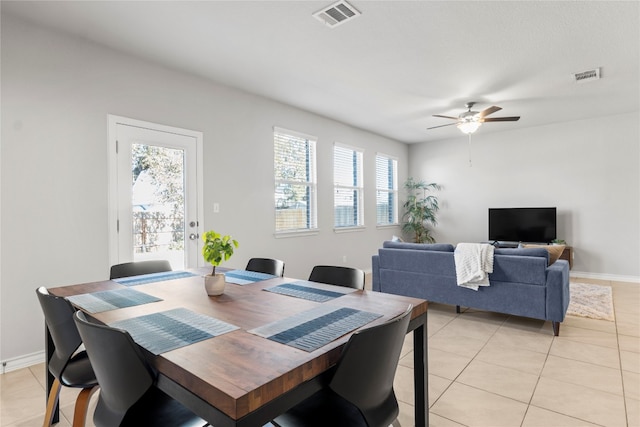 tiled dining area with ceiling fan