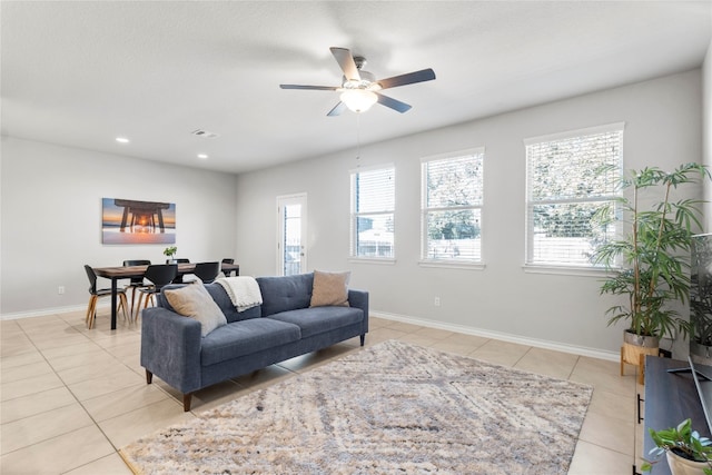 tiled living room featuring ceiling fan