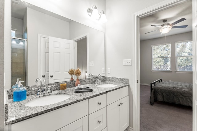 bathroom with vanity, a shower with door, and ceiling fan