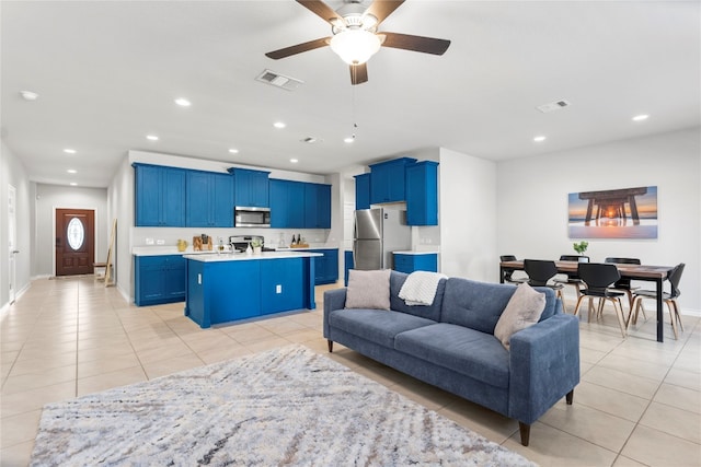 living room with ceiling fan and light tile patterned floors