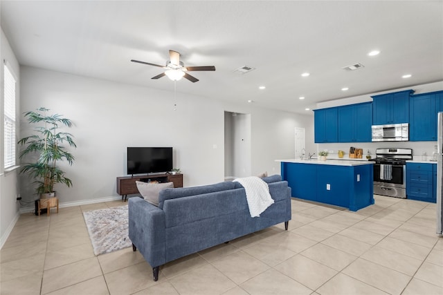 living room with a healthy amount of sunlight, ceiling fan, and light tile patterned flooring