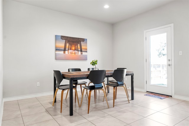 tiled dining space featuring plenty of natural light