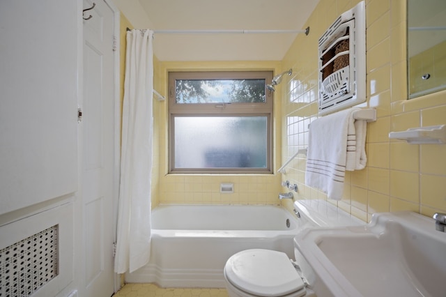 full bathroom with shower / bath combo, tile patterned floors, toilet, tile walls, and sink