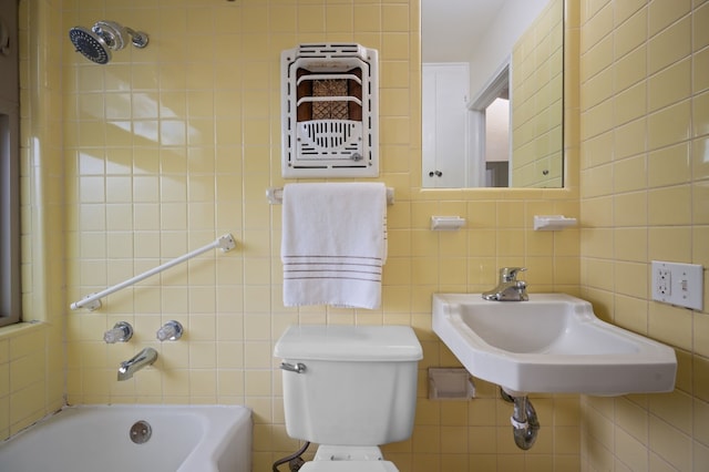 full bathroom featuring tile walls, tiled shower / bath combo, sink, and toilet