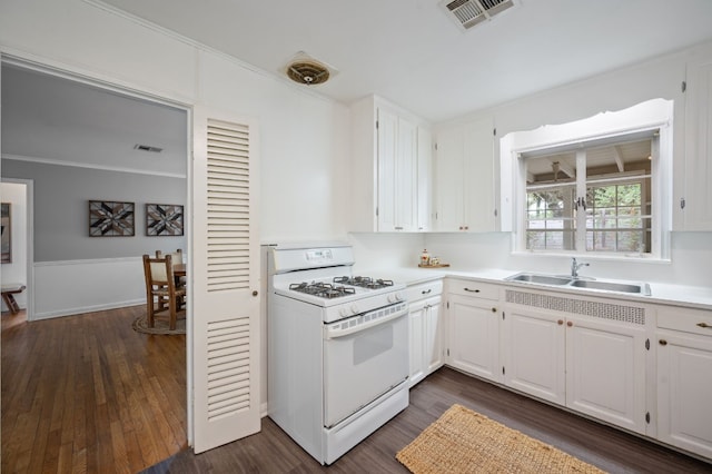 kitchen featuring white cabinets, dark hardwood / wood-style floors, sink, and white gas range oven