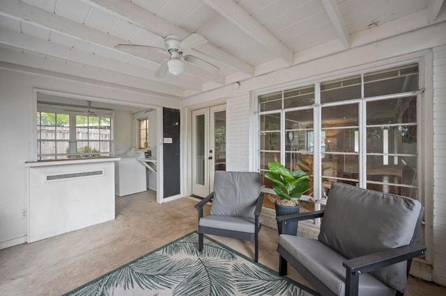 sunroom / solarium featuring beamed ceiling and ceiling fan