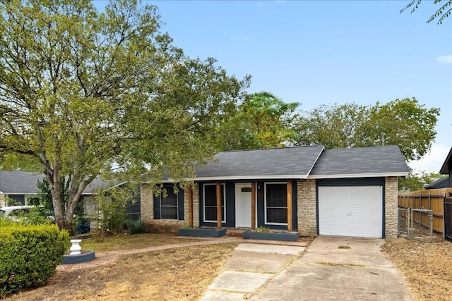 ranch-style home featuring covered porch and a garage