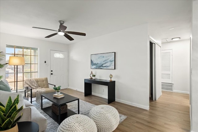 living room with ceiling fan and light hardwood / wood-style floors