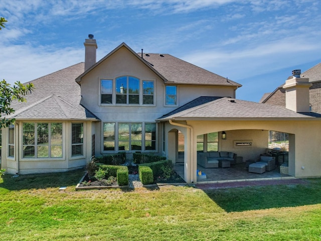 back of property with a patio, a yard, and an outdoor hangout area