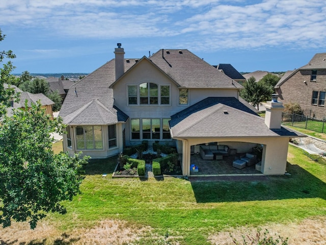 rear view of house featuring a lawn