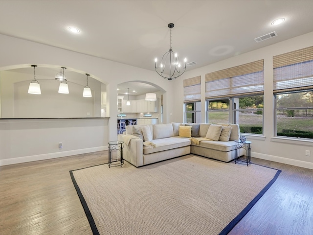 living room featuring hardwood / wood-style flooring and a chandelier