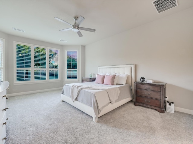 bedroom featuring light colored carpet and ceiling fan