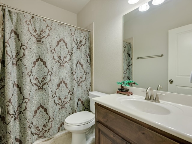 bathroom featuring tile patterned floors, vanity, and toilet