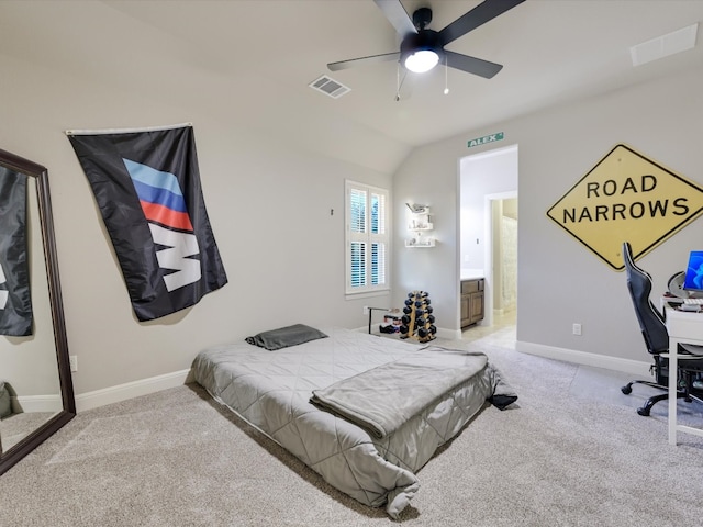 bedroom with ensuite bathroom, ceiling fan, light carpet, and vaulted ceiling