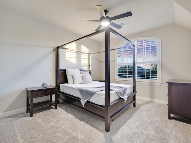 bedroom with light carpet, ceiling fan, and vaulted ceiling