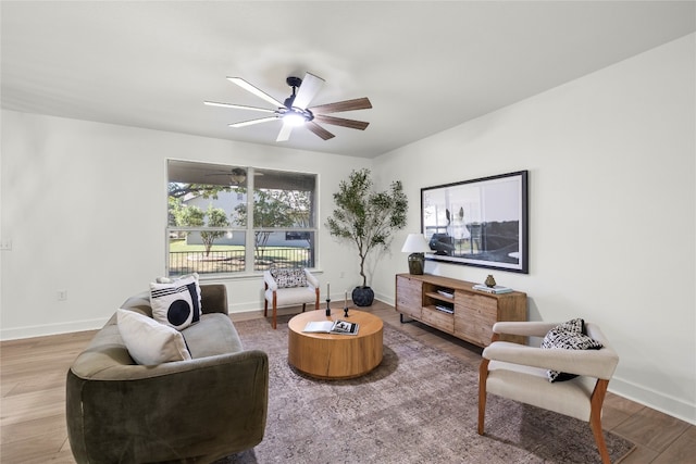 living room featuring hardwood / wood-style flooring and ceiling fan