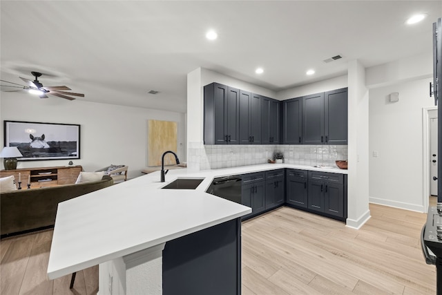 kitchen with light hardwood / wood-style floors, dishwasher, kitchen peninsula, sink, and gray cabinets