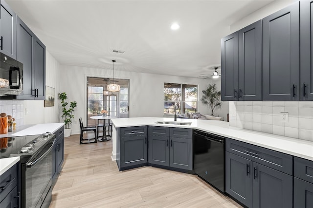 kitchen with backsplash, light hardwood / wood-style floors, and stainless steel appliances