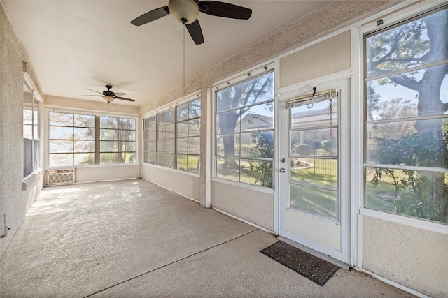 unfurnished sunroom with ceiling fan